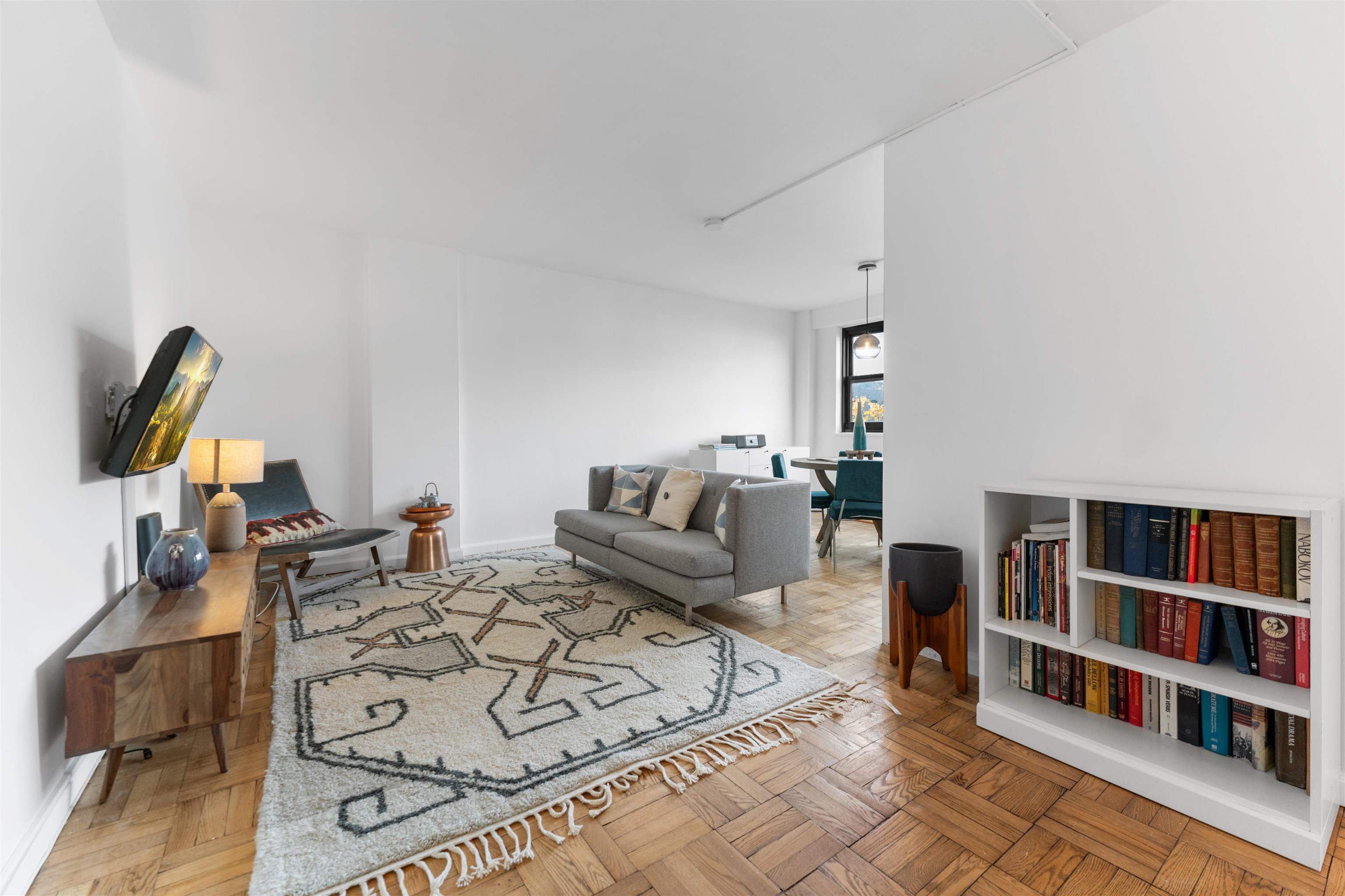 6515 JFK Boulevard East, Unit 4C West New York, NJ 07093 - Photo 5 of 14 a living room with furniture a rug and a book shelf