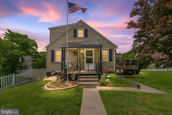 a front view of a house with a yard table and chairs