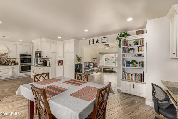 a view of a dining room with furniture and wooden floor