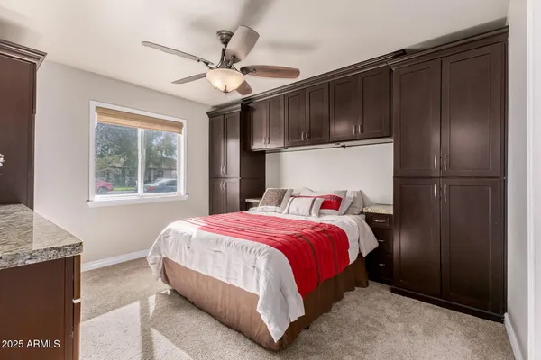 a bedroom with a large bed and a window