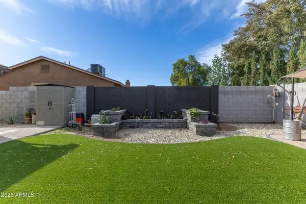 a view of backyard with house and outdoor seating