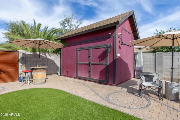 a view of a backyard with a patio and outdoor seating
