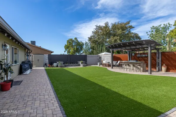 a view of a patio with table and chairs potted plants with wooden fence