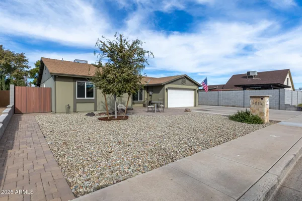 a house view with a sitting space and garden