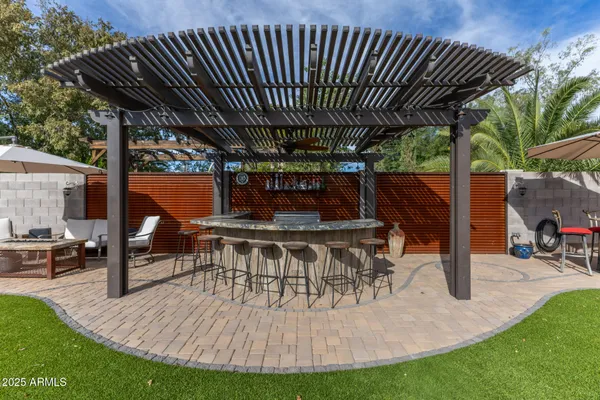 a view of a chairs and table in patio with wooden fence