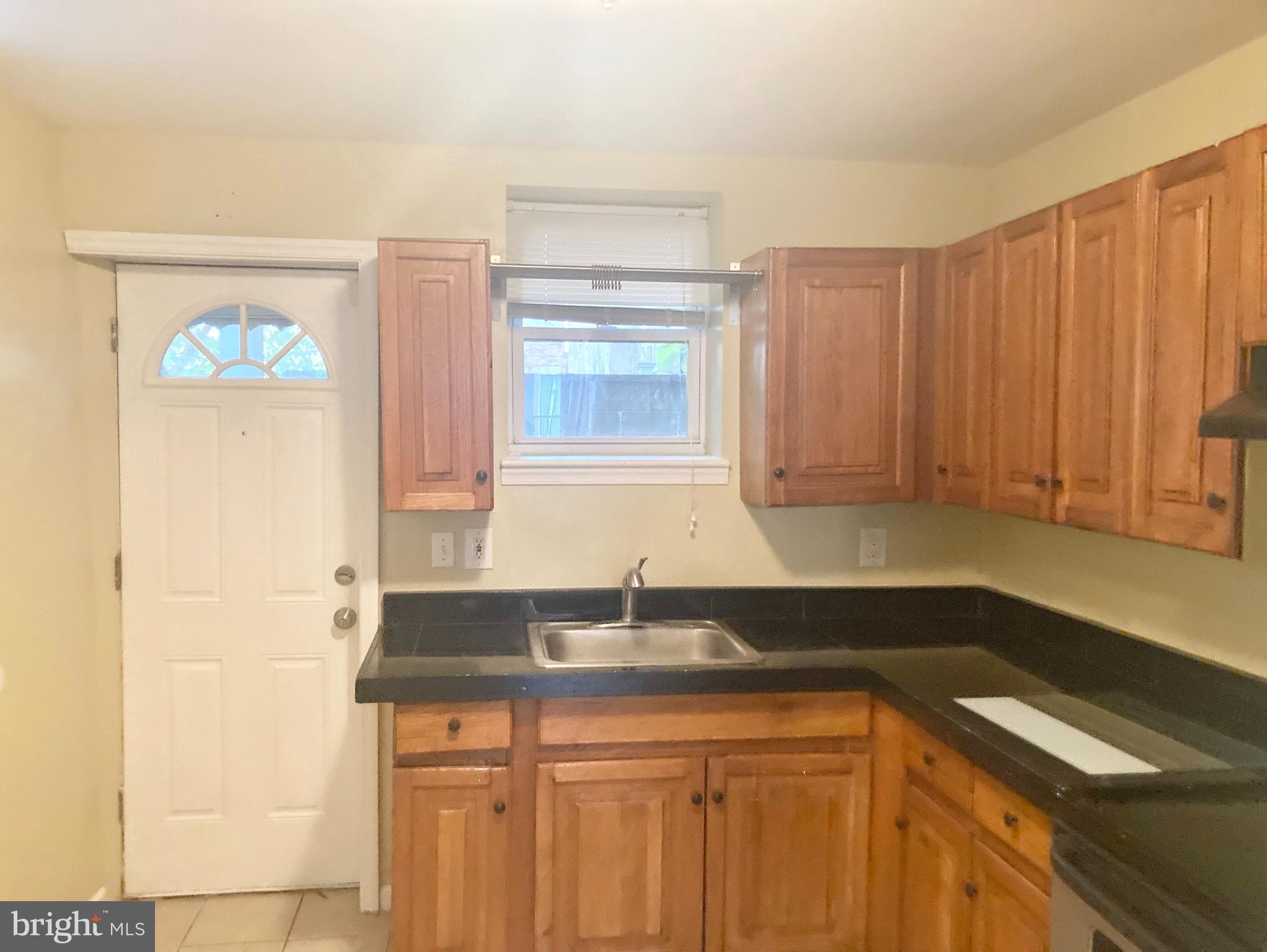 2624 Gerritt Street Philadelphia, PA 19146 - Photo 3 of 10 a kitchen with a sink cabinets and a window