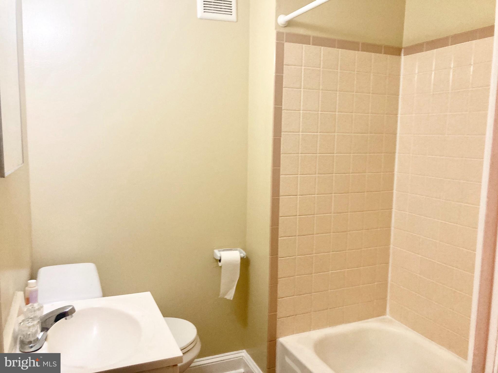 2624 Gerritt Street Philadelphia, PA 19146 - Photo 8 of 10 a white toilet sitting next to a bathroom sink and a shower