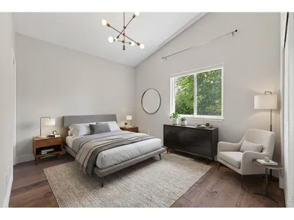 a bedroom with bed couch and window