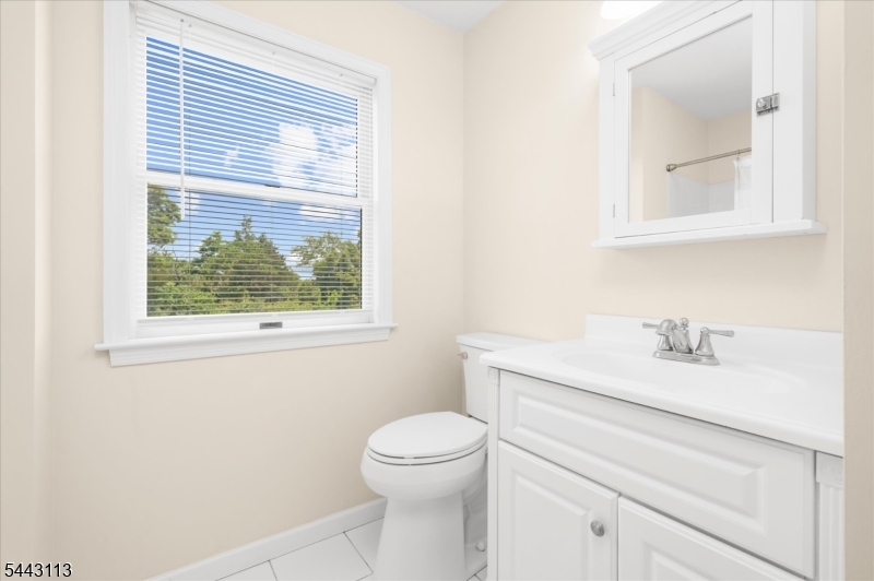 54 Rick Road Milford, NJ 08848 - Photo 23 of 50 a bathroom with a granite countertop toilet a sink a vanity and a window