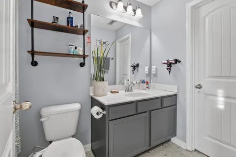 a bathroom with a toilet sink and mirror