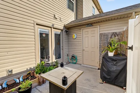 a view of house with chairs and potted plants