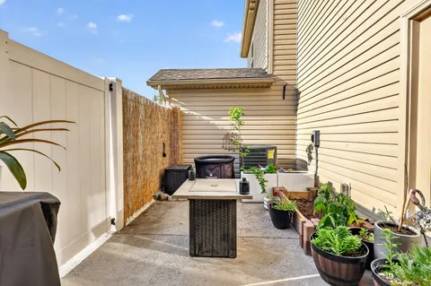a building outdoor space with patio furniture and potted plants
