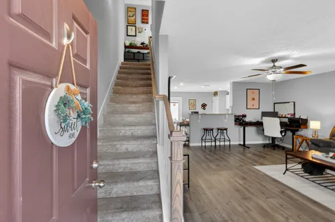 a view of entryway and hall with wooden floor