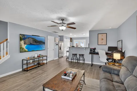 a living room with furniture and wooden floor