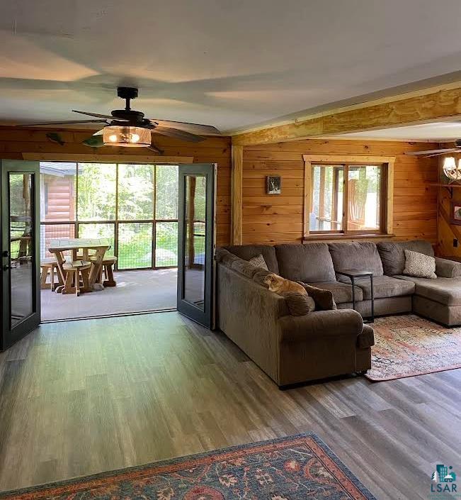 1896 Echo Trail Ely, MN 55731 - Photo 17 of 20 Living area with ceiling fan, wood finished floors, french doors, and wooden walls