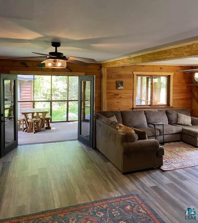 1896 Echo Trail Ely, MN 55731 - Photo 4 of 20 Living area with wood finished floors, a ceiling fan, and wood walls