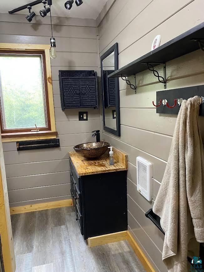1896 Echo Trail Ely, MN 55731 - Photo 7 of 20 Bathroom featuring vanity, light wood-type flooring, and wood walls