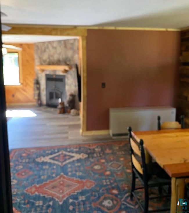 1896 Echo Trail Ely, MN 55731 - Photo 8 of 20 Dining space with a fireplace and wood finished floors