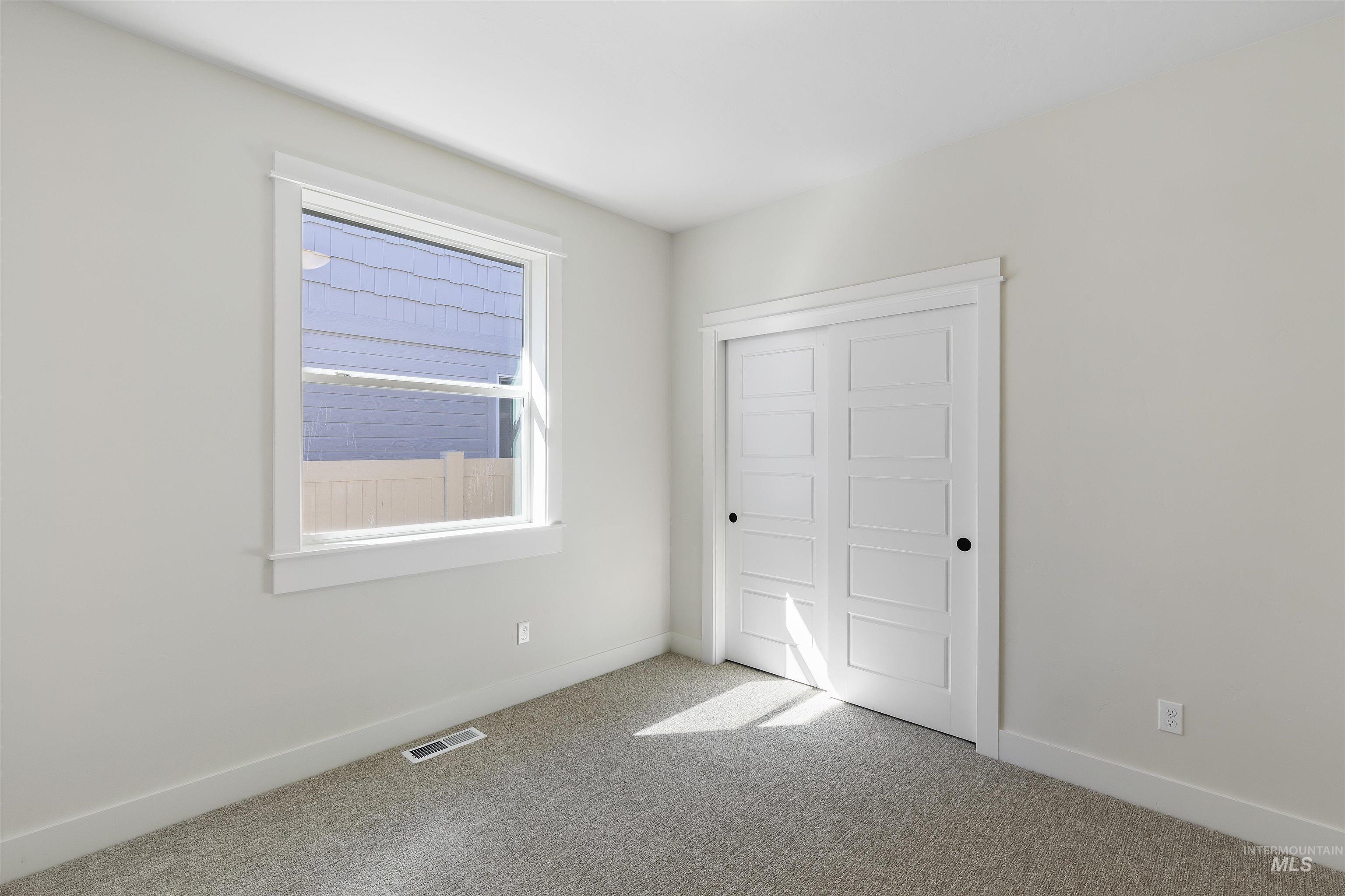 3501 South El Rio Avenue Boise, ID 83709 - Photo 25 of 31 Unfurnished bedroom with light carpet and a closet
