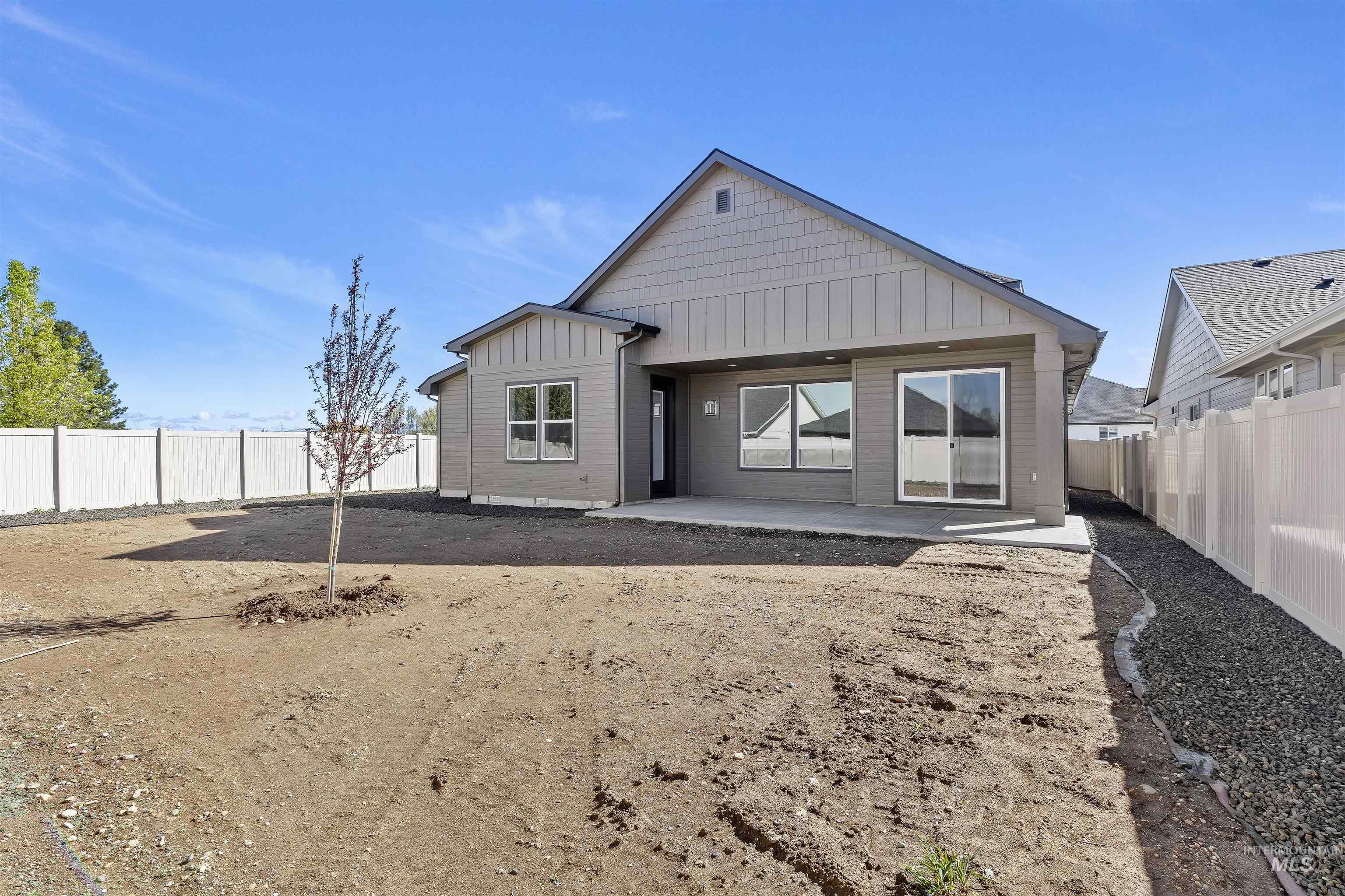 3501 South El Rio Avenue Boise, ID 83709 - Photo 29 of 31 Rear view of property with board and batten siding, a patio, and a fenced backyard
