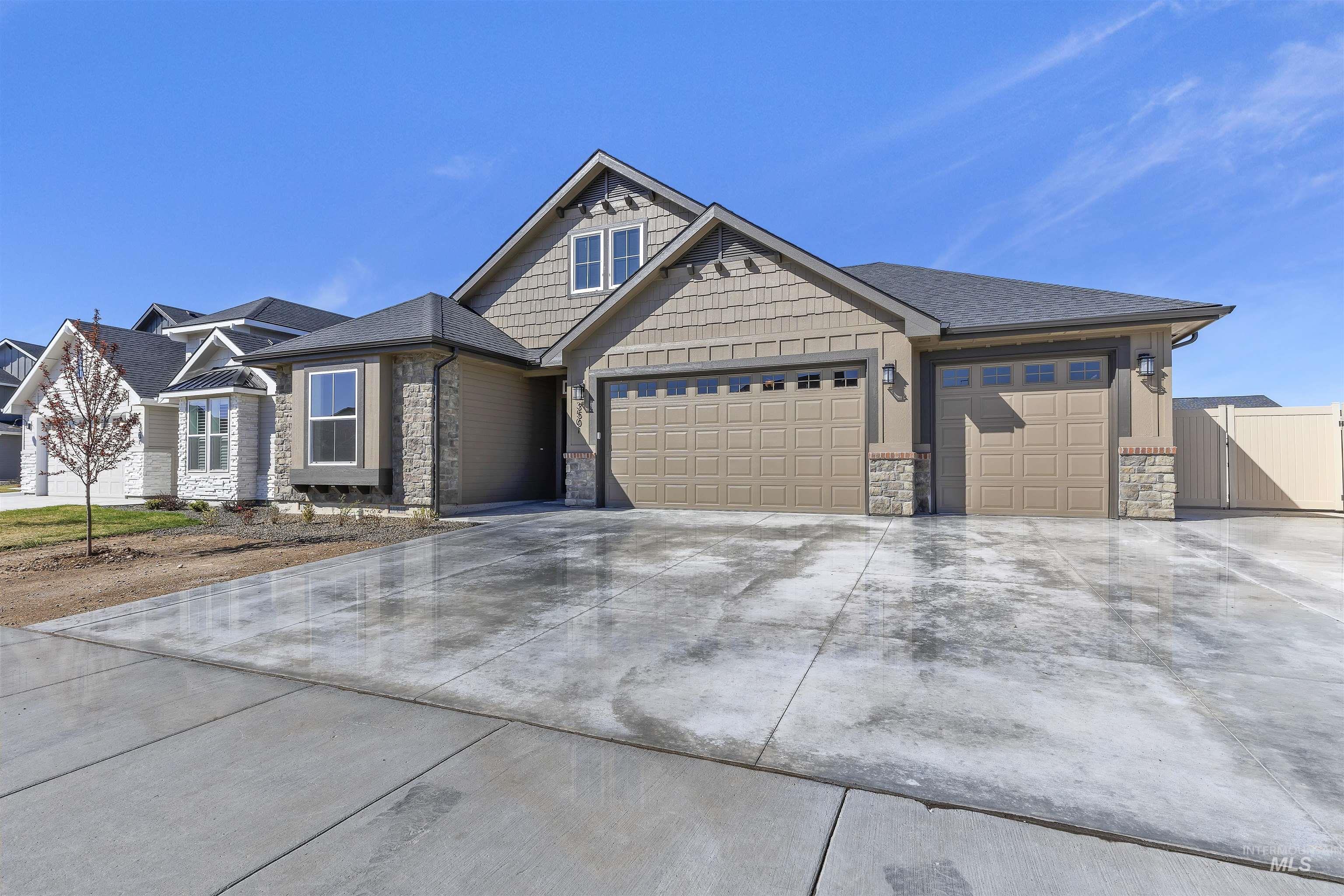 3501 South El Rio Avenue Boise, ID 83709 - Photo 3 of 31 Craftsman house with a garage, stone siding, and concrete driveway