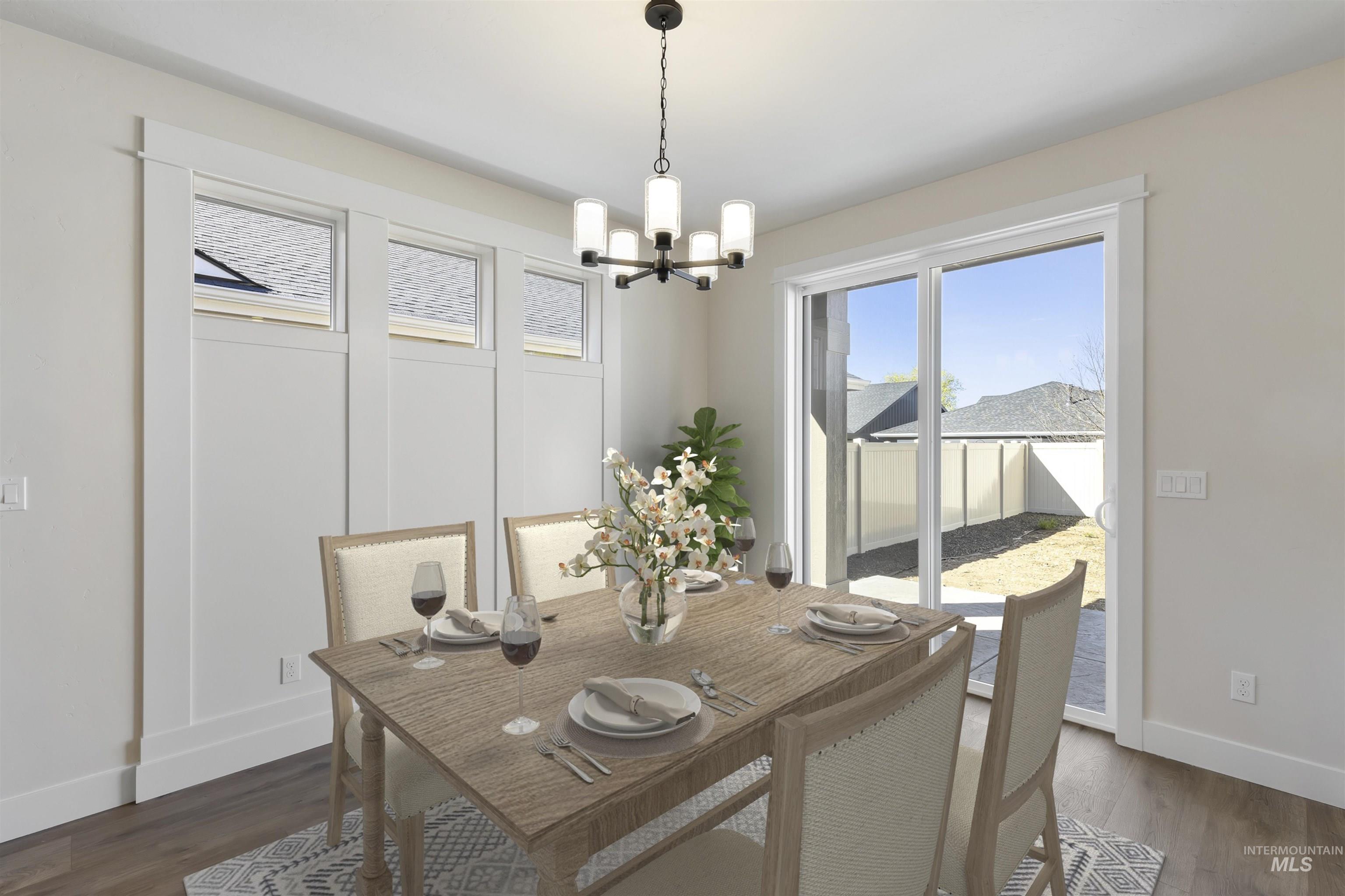 3501 South El Rio Avenue Boise, ID 83709 - Photo 7 of 31 Dining room featuring dark wood-type flooring and a chandelier