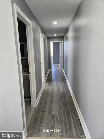 a view of gallery with wooden floor