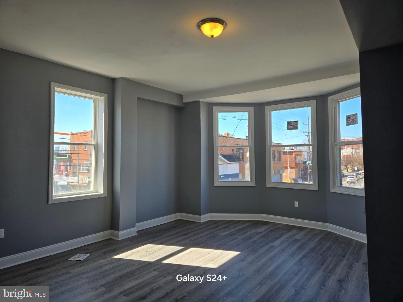 3301 North Front Street Philadelphia, PA 19140 - Photo 7 of 9 a view of an empty room with window and wooden floor
