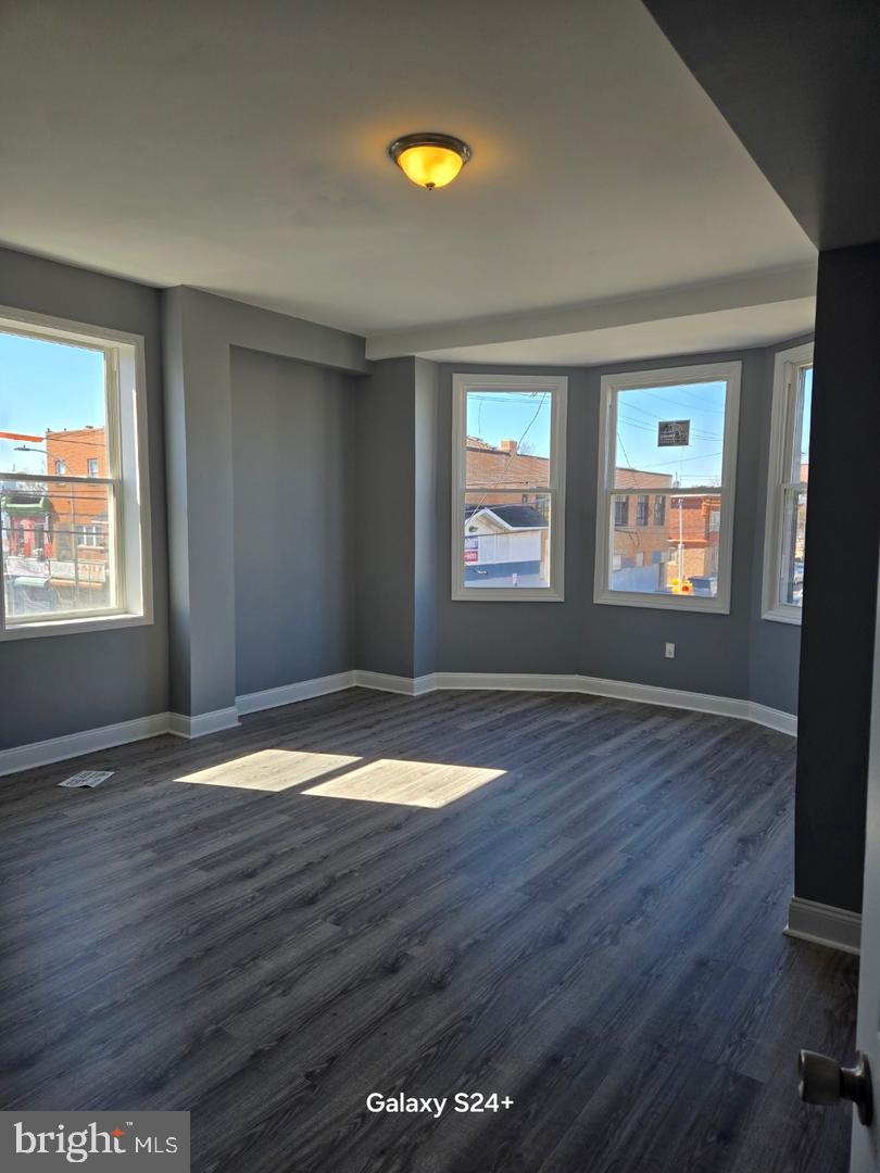 3301 North Front Street Philadelphia, PA 19140 - Photo 8 of 9 an empty room with wooden floor and windows