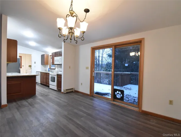 a view of a kitchen with wooden floor and a window