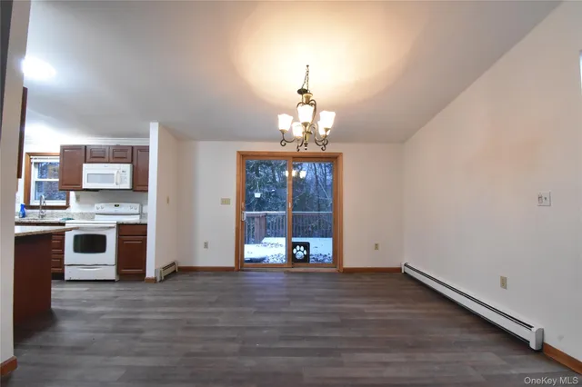 a view of a kitchen with granite countertop a stove top oven