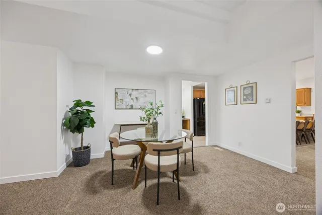a dining room with furniture and potted plant