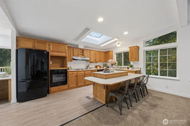 a kitchen with a refrigerator a kitchen island a stove and a refrigerator