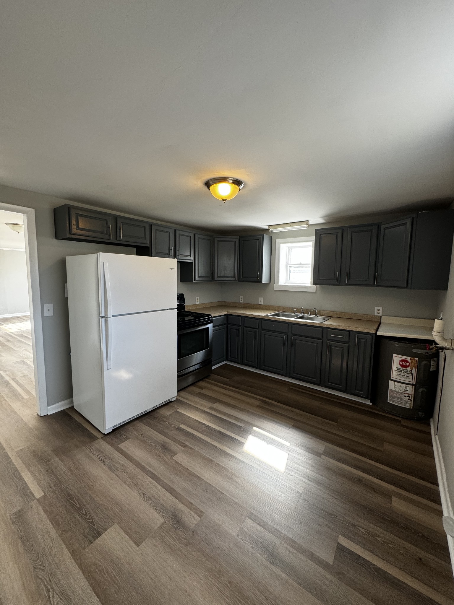 1814 County Hospital Road Nashville, TN 37218 - Photo 12 of 18 a kitchen with wooden floors and appliances