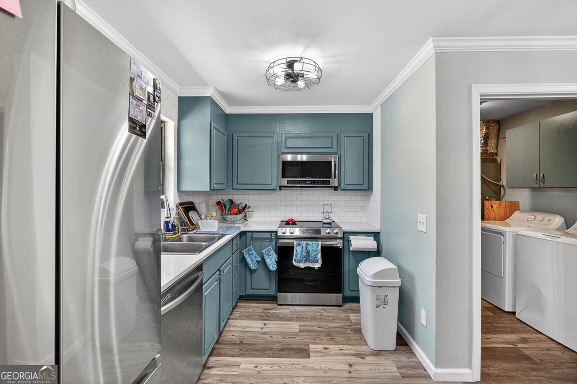 33 Warren Avenue Waverly, GA 31565 - Photo 5 of 63 a kitchen with a sink stainless steel appliances a counter top space and cabinets