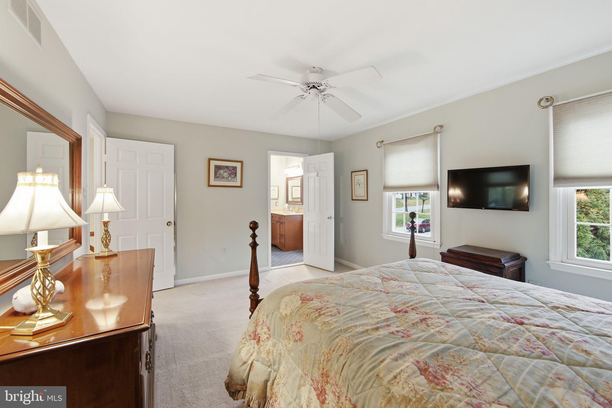 201 Penns Lane, Unit 201 Malvern, PA 19355 - Photo 19 of 30 a spacious bedroom with a bed and a flat screen tv