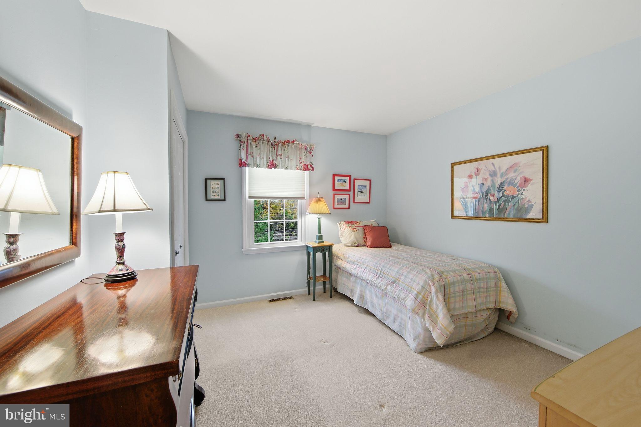 201 Penns Lane, Unit 201 Malvern, PA 19355 - Photo 22 of 30 a bedroom with a bed and a dresser