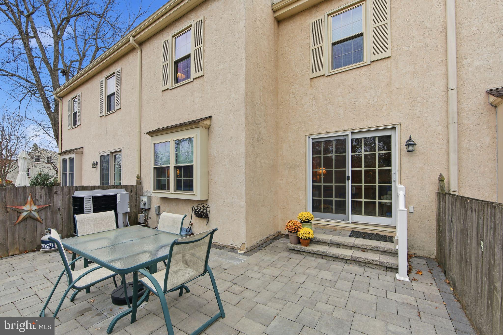201 Penns Lane, Unit 201 Malvern, PA 19355 - Photo 29 of 30 a backyard of a house with barbeque oven table and chairs