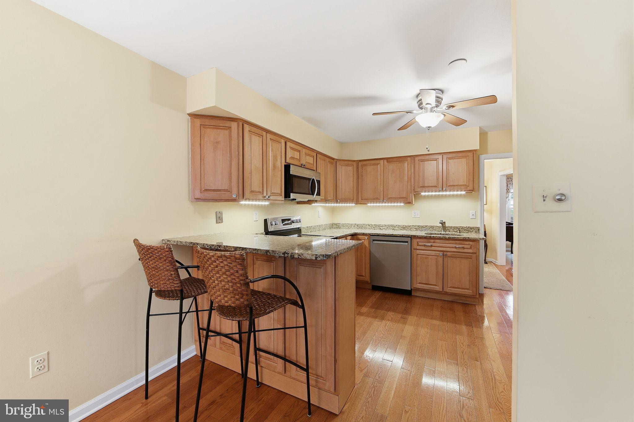 201 Penns Lane, Unit 201 Malvern, PA 19355 - Photo 3 of 30 a kitchen with a table and chairs in it