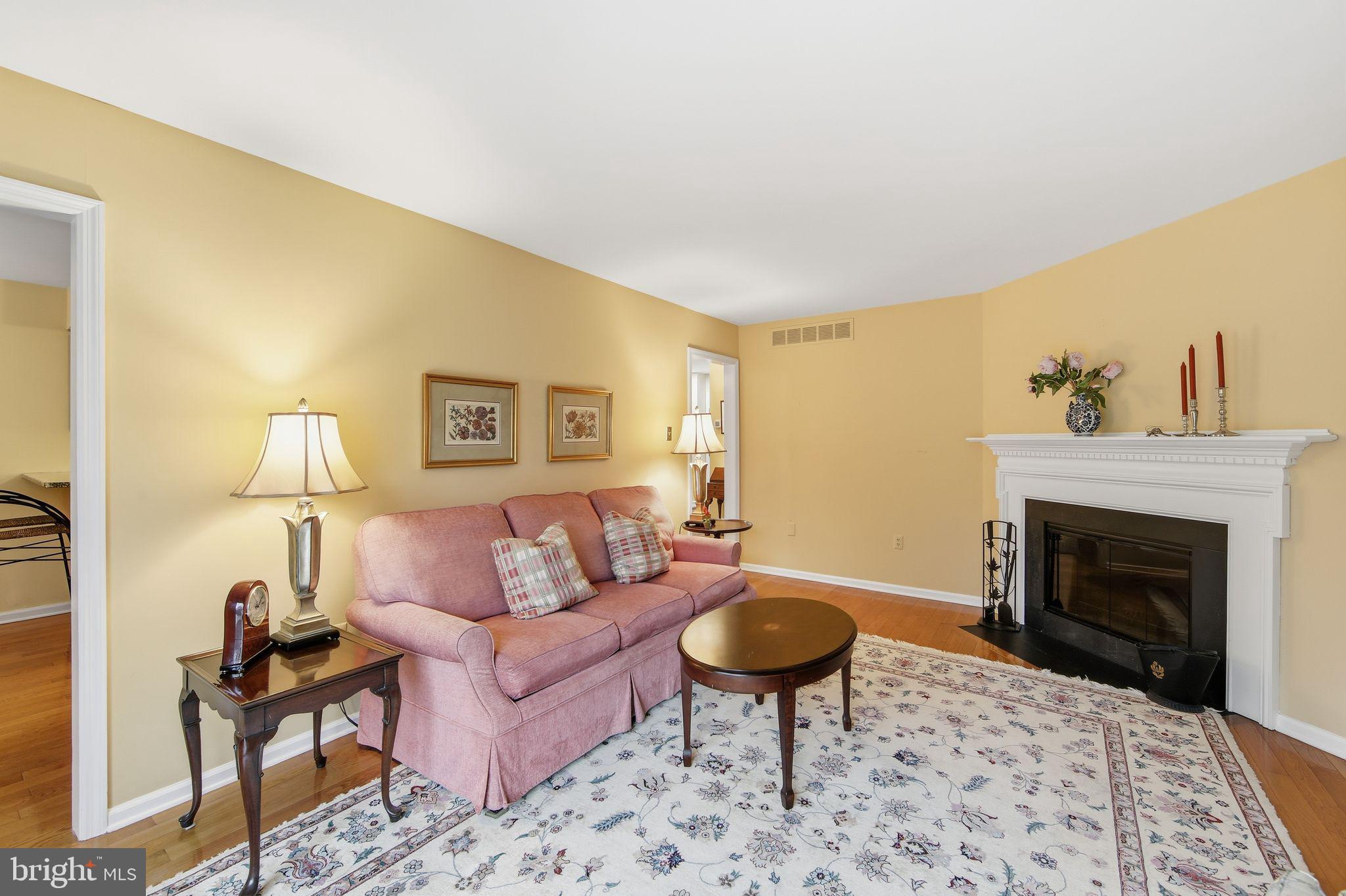 201 Penns Lane, Unit 201 Malvern, PA 19355 - Photo 9 of 30 a living room with furniture a rug and a fireplace