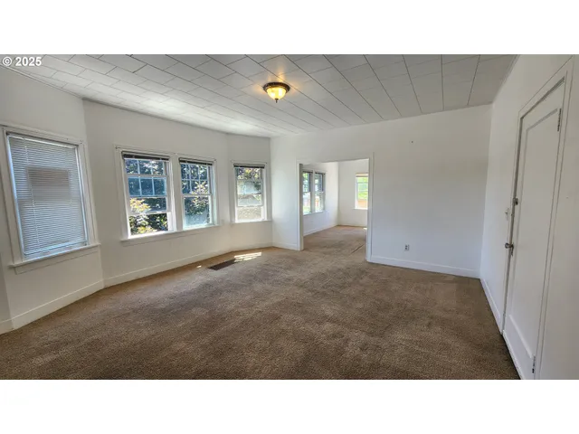 a living room with a couch and windows