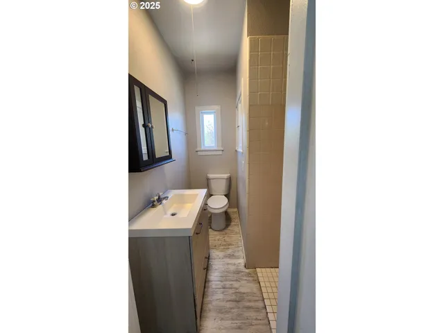 a bathroom with a sink a toilet and mirror
