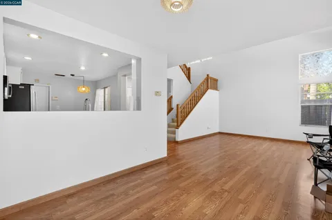 a view of a kitchen and wooden floor