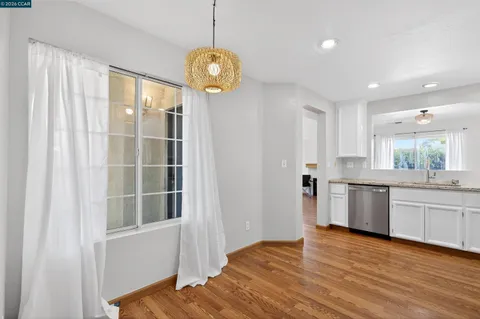 a kitchen with a refrigerator and white cabinets