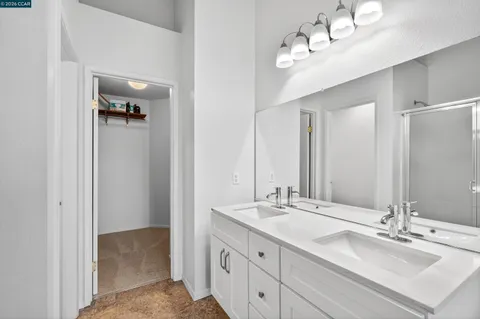 a bathroom with a double vanity sink and mirror