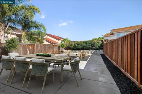 a view of a dinning table and chairs in patio