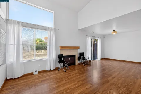 a view of a livingroom with wooden floor and a window