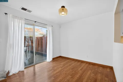 a view of a room with wooden floor and a window