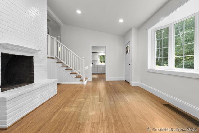 89 Book Hill Road Essex, CT 06426 - Photo 11 of 40 a view of empty room with wooden floor and fireplace