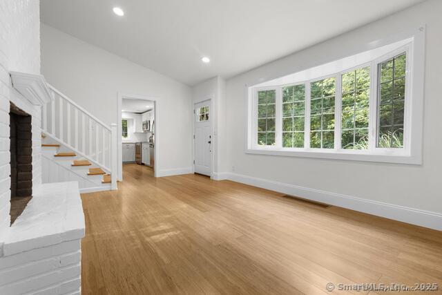 89 Book Hill Road Essex, CT 06426 - Photo 12 of 40 a view of an empty room with wooden floor and a window